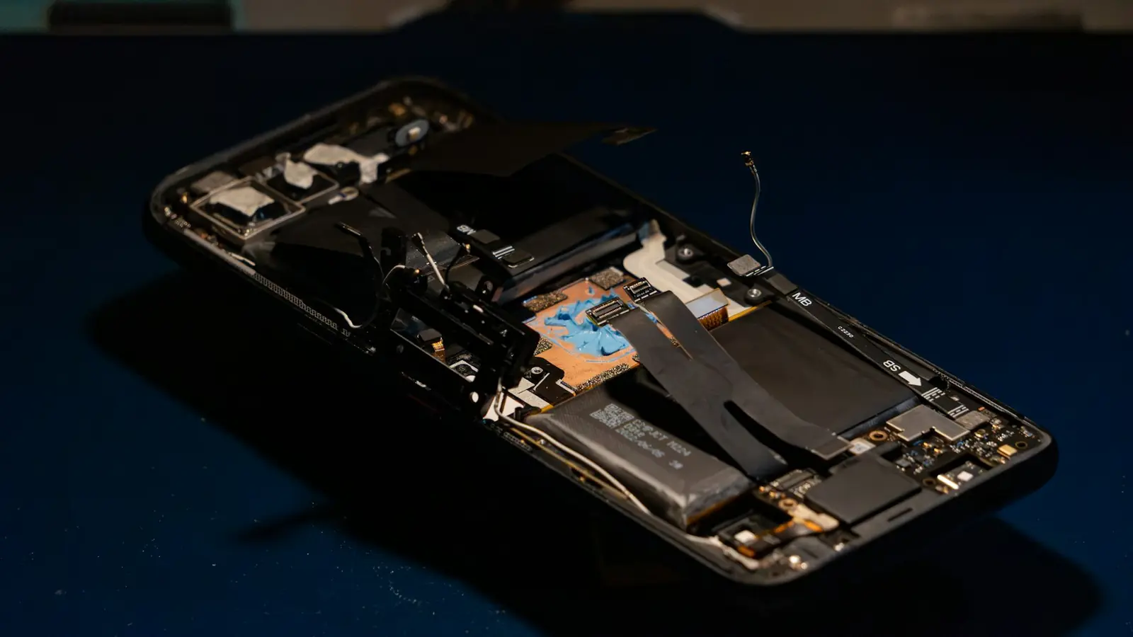A smartphone opened up showing its internal components